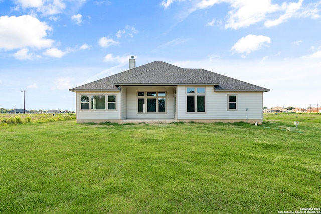 rear view of house with a yard