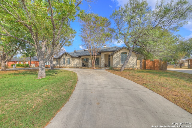 ranch-style home with a front lawn