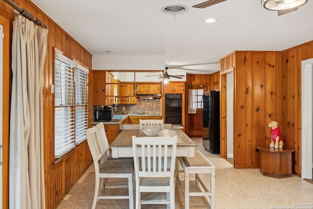 dining space with wood walls