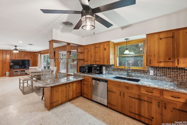 kitchen with kitchen peninsula, tasteful backsplash, stainless steel dishwasher, and sink