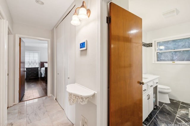 bathroom featuring hardwood / wood-style floors, vanity, and toilet