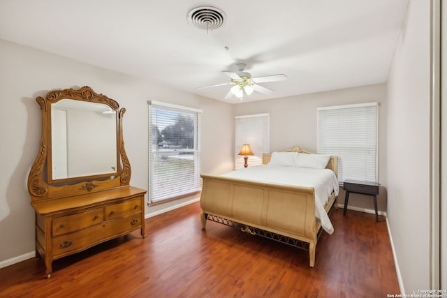 bedroom with dark hardwood / wood-style floors and ceiling fan