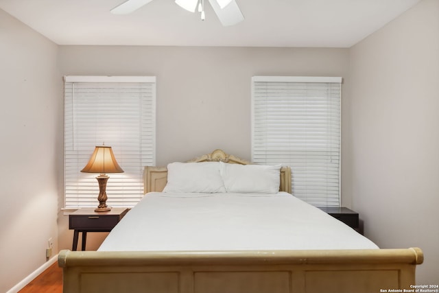 bedroom with ceiling fan and wood-type flooring