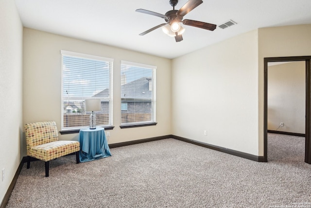 living area with carpet floors and ceiling fan