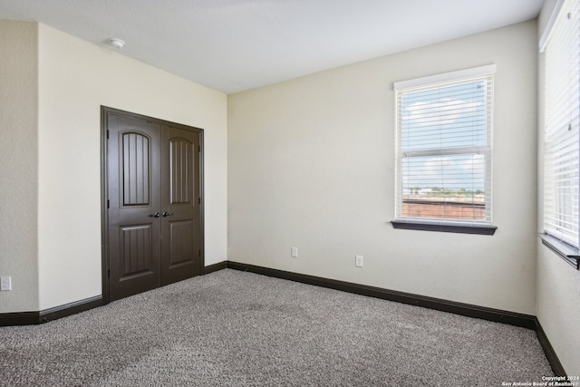 carpeted empty room with a wealth of natural light