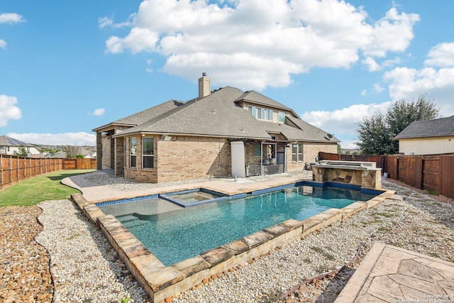 view of swimming pool featuring a patio and an in ground hot tub