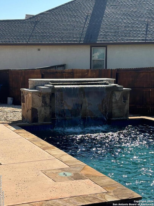 view of pool featuring pool water feature