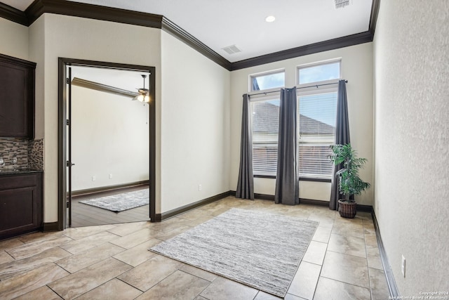 doorway with ornamental molding and light wood-type flooring