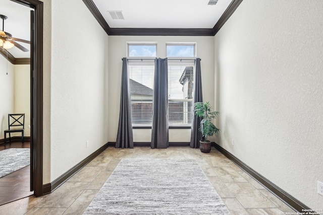 unfurnished room with ceiling fan and crown molding