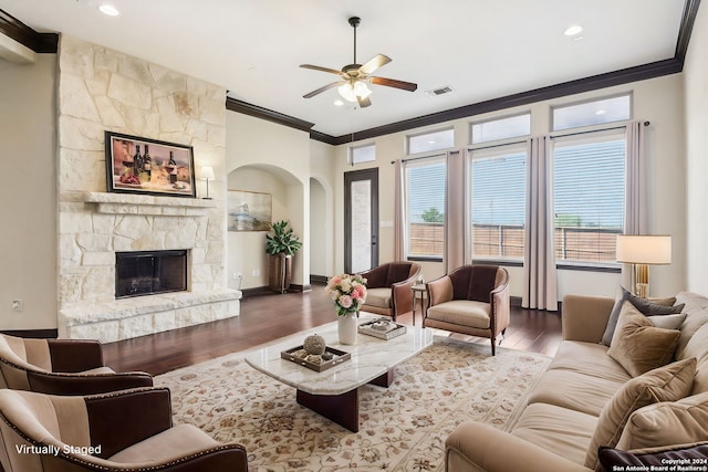 living room with ornamental molding, a fireplace, plenty of natural light, and hardwood / wood-style flooring