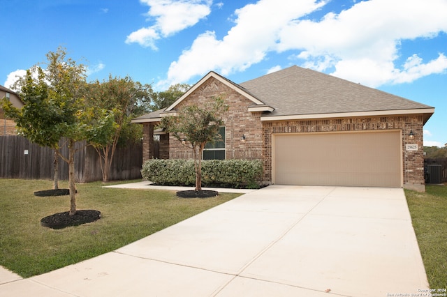 view of front facade featuring a garage, central AC, and a front yard