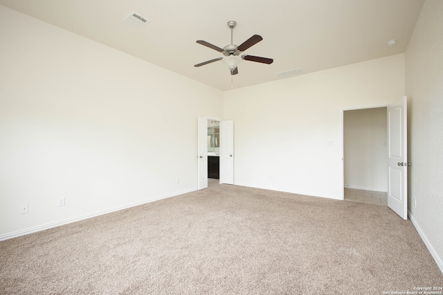 unfurnished bedroom featuring light carpet and ceiling fan