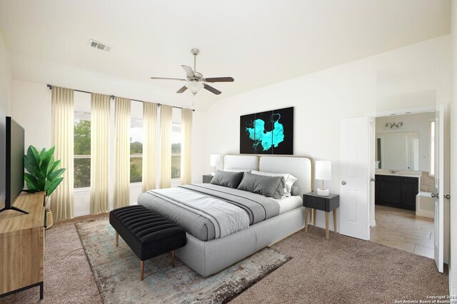 bedroom with light carpet, ceiling fan, and ensuite bath