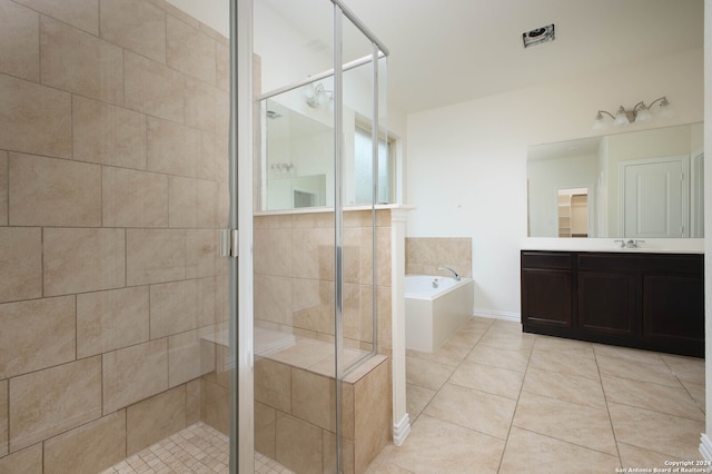 bathroom featuring vanity, tile patterned flooring, and separate shower and tub