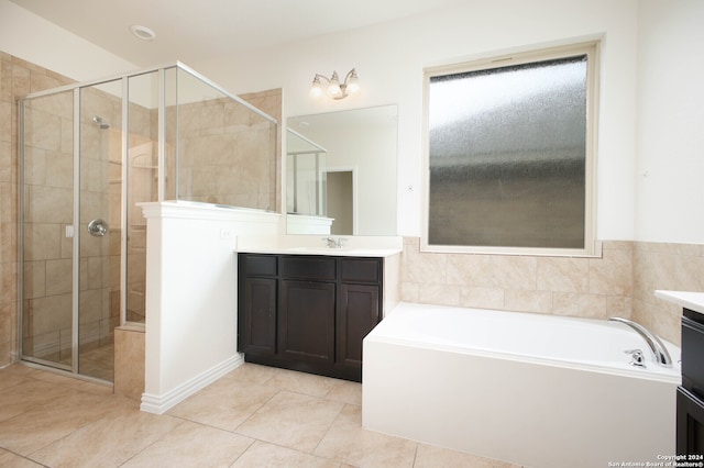 bathroom featuring vanity, tile patterned floors, and plus walk in shower