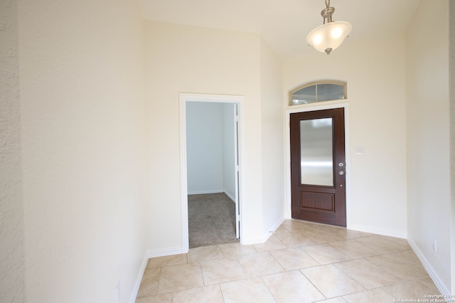 tiled foyer with a towering ceiling