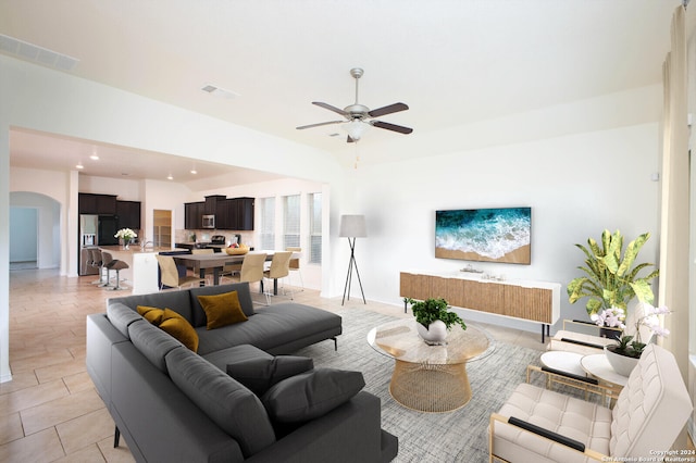 living room featuring ceiling fan and light tile patterned floors