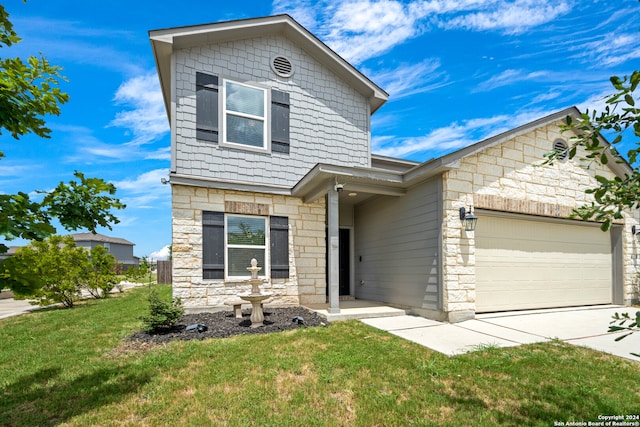 view of front of house featuring a front yard and a garage