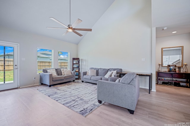 living room featuring ceiling fan, light hardwood / wood-style flooring, and high vaulted ceiling