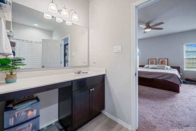 bathroom featuring vanity, ceiling fan, wood-type flooring, and a shower with curtain