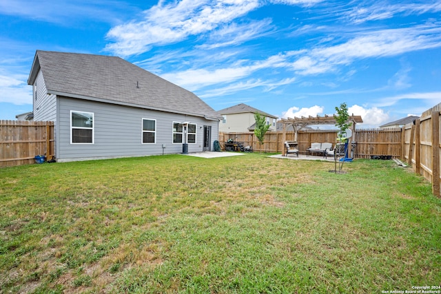 rear view of property featuring a lawn and a patio area