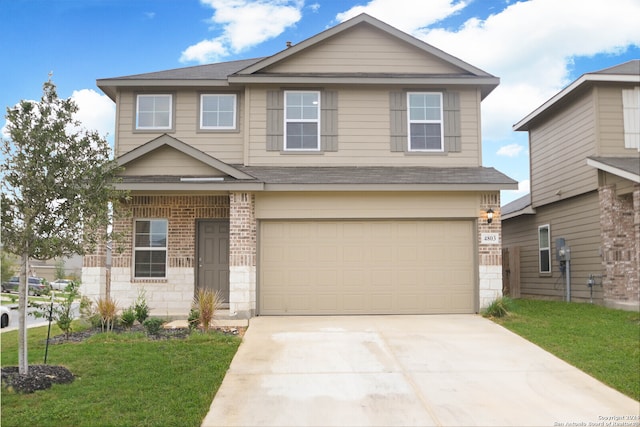 view of front of house featuring a front lawn and a garage