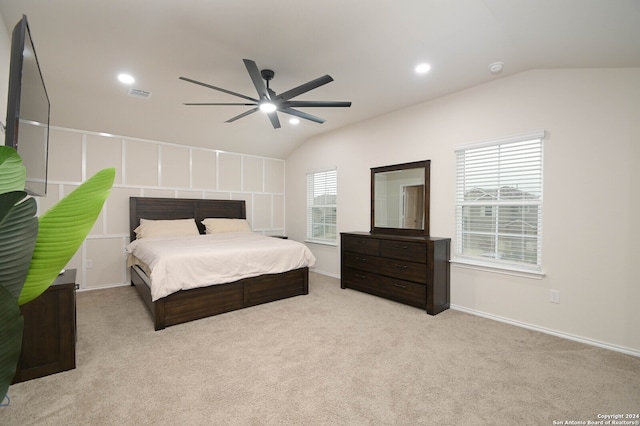 bedroom with light colored carpet, lofted ceiling, and ceiling fan