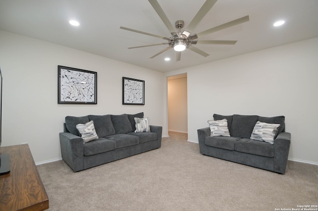 carpeted living room with ceiling fan