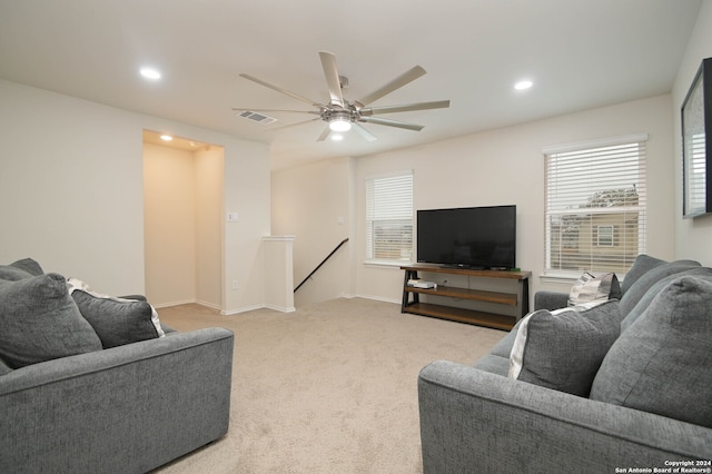 living room featuring light colored carpet and ceiling fan