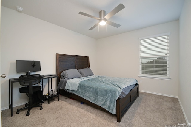 bedroom with light colored carpet and ceiling fan