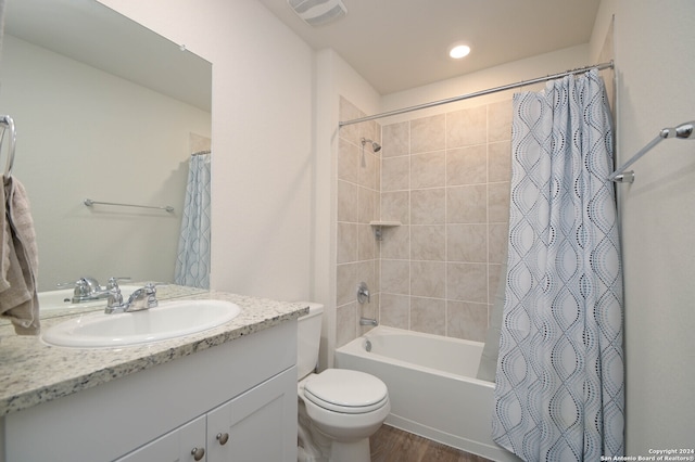 full bathroom with toilet, shower / bath combo, vanity, and wood-type flooring