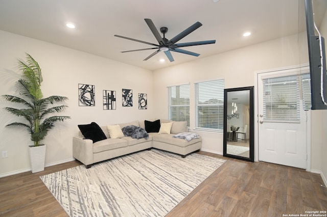 living room featuring dark hardwood / wood-style flooring and ceiling fan