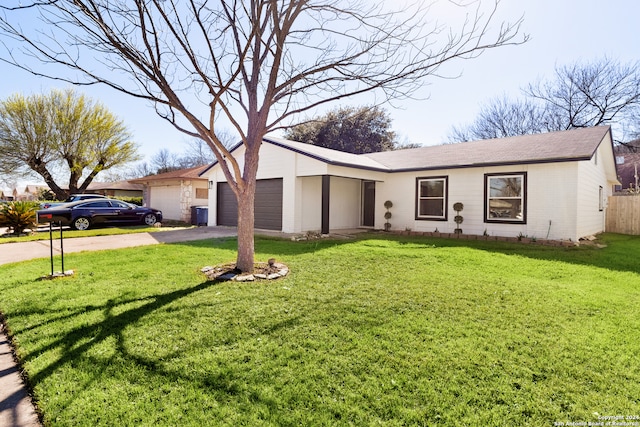 ranch-style home with a garage and a front lawn