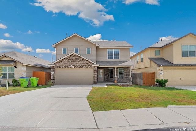 view of front of property with a garage and a front yard