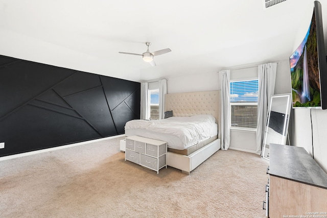 carpeted bedroom featuring multiple windows and ceiling fan