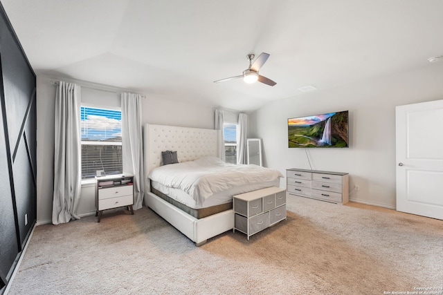 bedroom featuring vaulted ceiling, light colored carpet, and ceiling fan