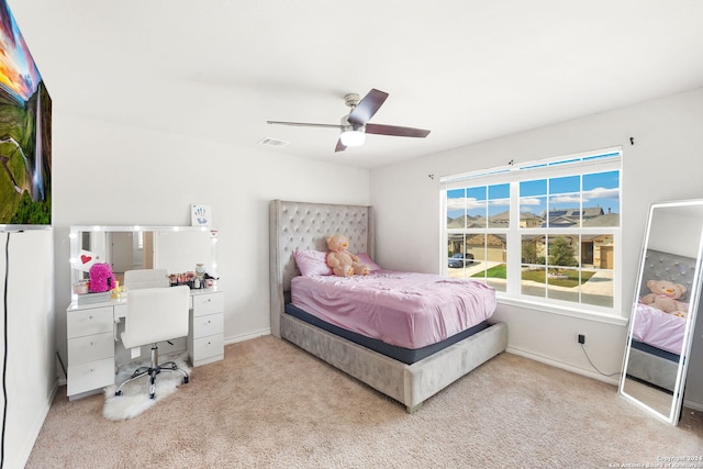 bedroom with ceiling fan and light carpet