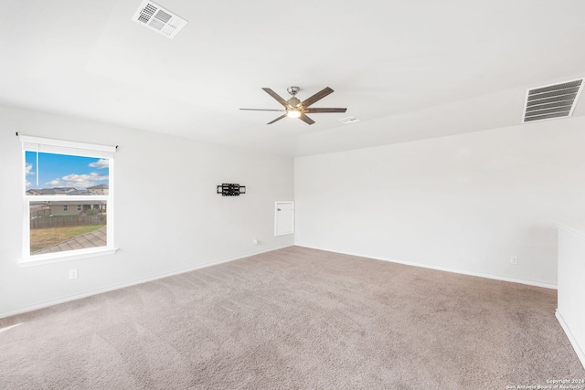 spare room featuring ceiling fan and carpet