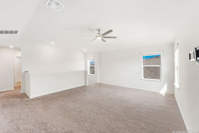 empty room featuring light colored carpet and ceiling fan