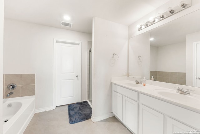 bathroom with vanity, a tub, and tile patterned flooring