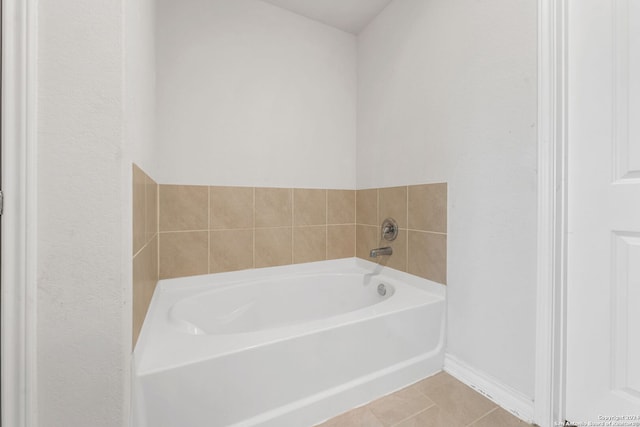 bathroom with tile patterned flooring and a bathtub