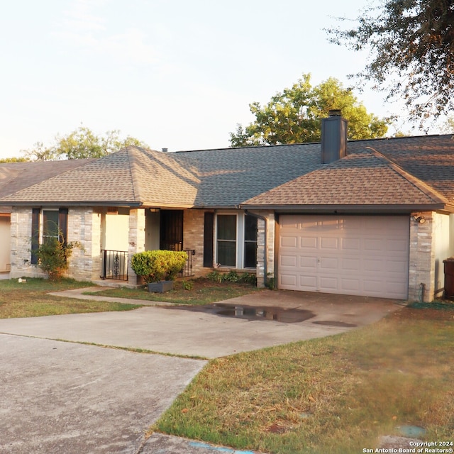 ranch-style house with a garage and a front yard