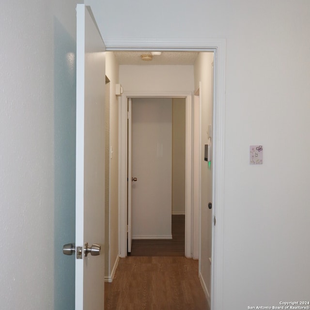 hallway featuring dark hardwood / wood-style flooring