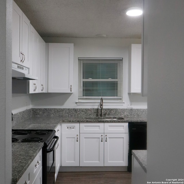 kitchen featuring white cabinets, black appliances, sink, and dark stone counters