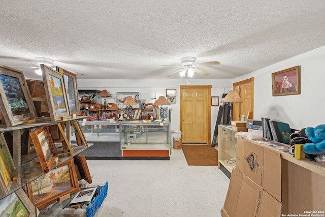 interior space featuring a textured ceiling and ceiling fan