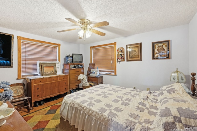 bedroom with a textured ceiling and ceiling fan