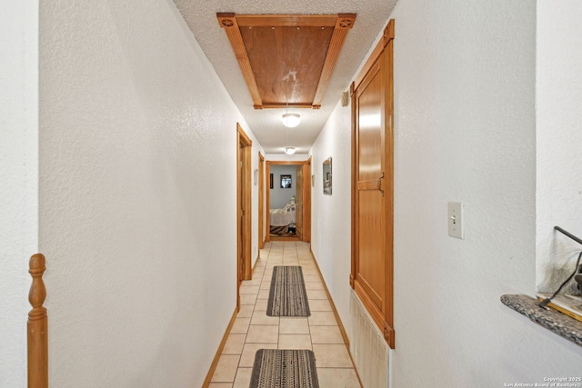 hall with light tile patterned floors