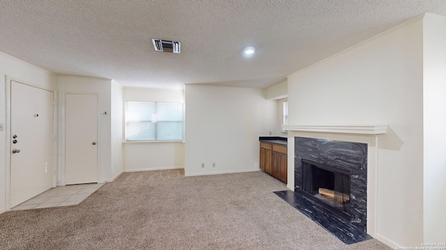 carpeted living room featuring a fireplace and a textured ceiling