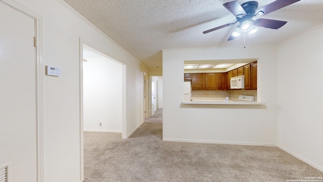 unfurnished living room featuring a textured ceiling, light carpet, and ceiling fan