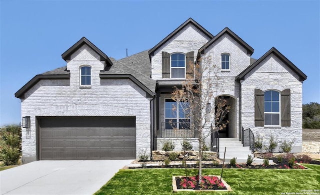 228 Dulce, Boerne, TX 78006 - french country style house with a front lawn, driveway, stone siding, and an attached garage